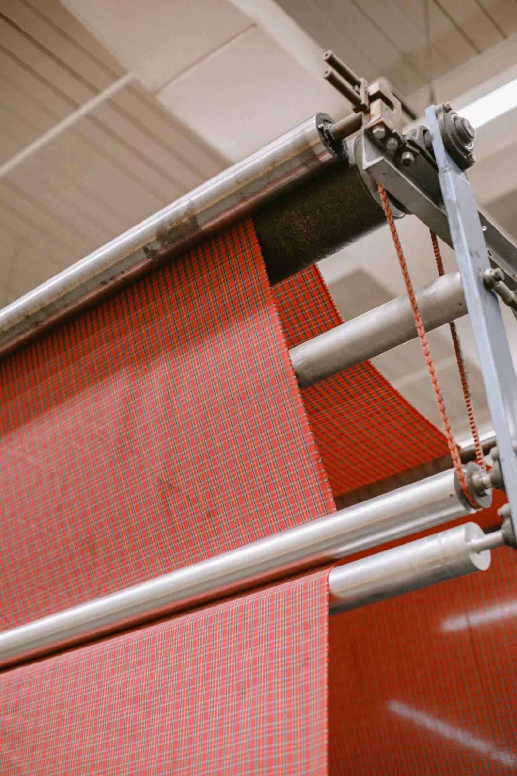 Bolt of red-checkered jacketing fabric on the cutting line