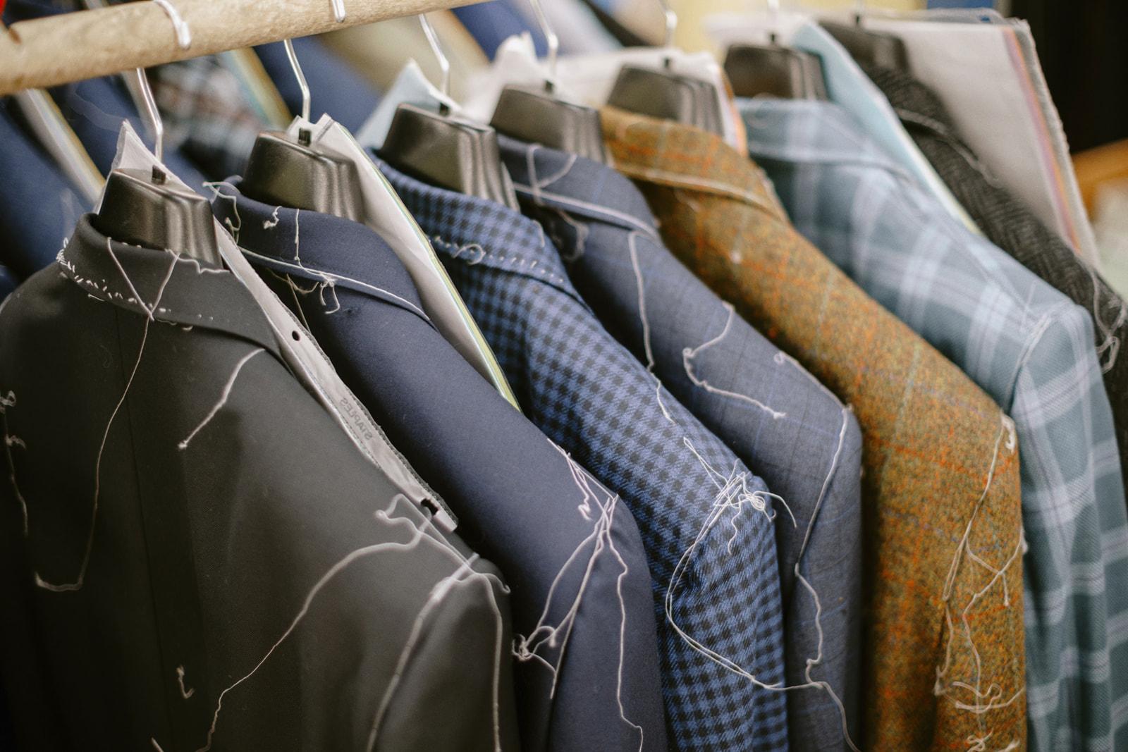 Basted jackets hanging on a rail at the factory floor